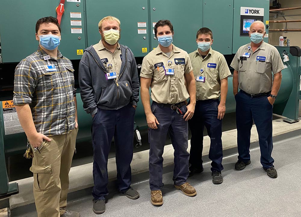 Union workers in masks looking at camera